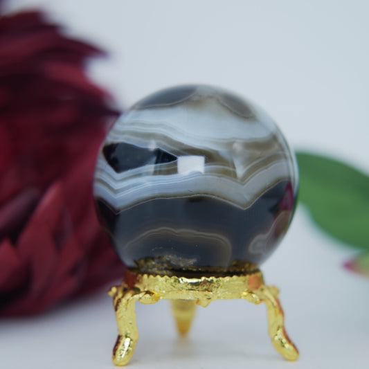 Polished Black and White Agate Sulemani Sphere 130g featuring banded patterns and glossy finish - Luna Panther