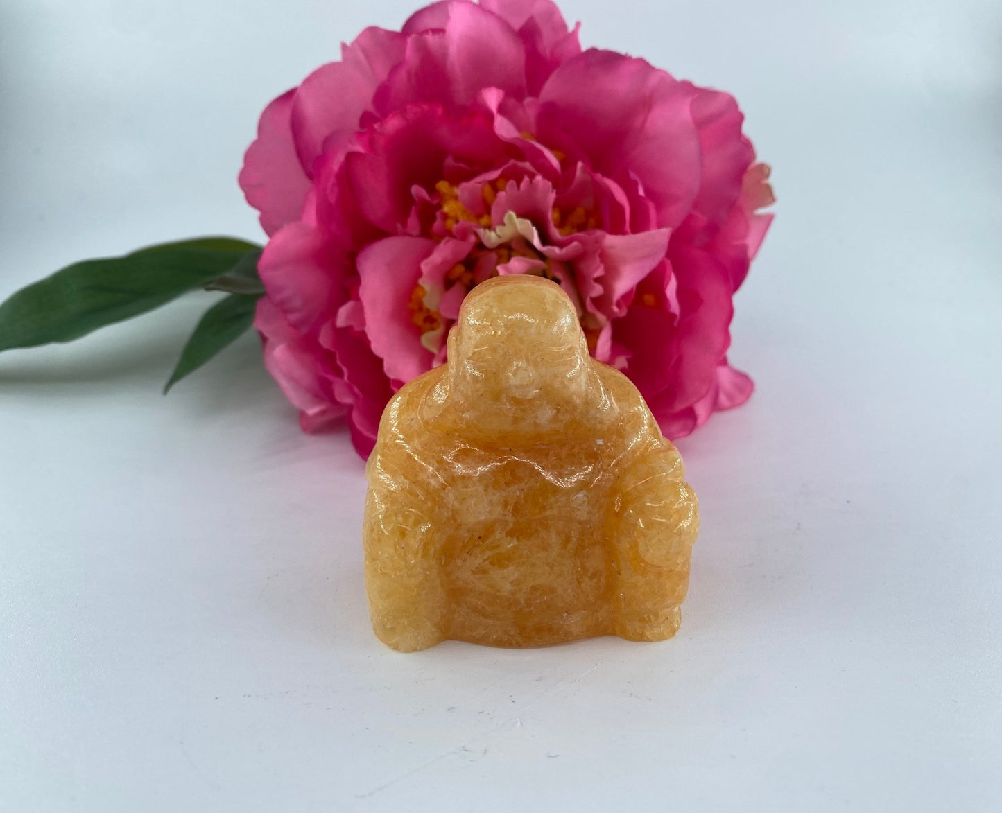 Polished Orange calcite Buddha featuring vivid orange tone and glassy sheen - Luna Panther