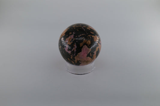 Polished Rhodonite Sphere 469 grams featuring pink tone with black veining - Luna Panther