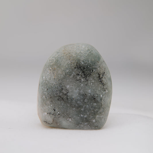 Sugar Amethyst druzy upright, its grey-green sparkling face crossed by branching dark mineral inclusions.