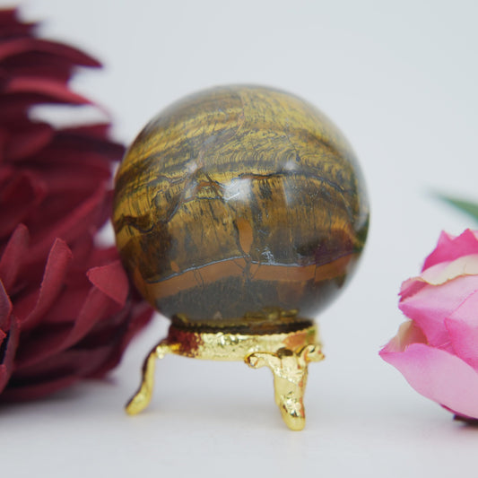 Polished Tigers Eye Sphere 215g 50mm featuring chatoyant golden-brown bands - Luna Panther