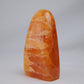 orange calcite freeform 328g front left view