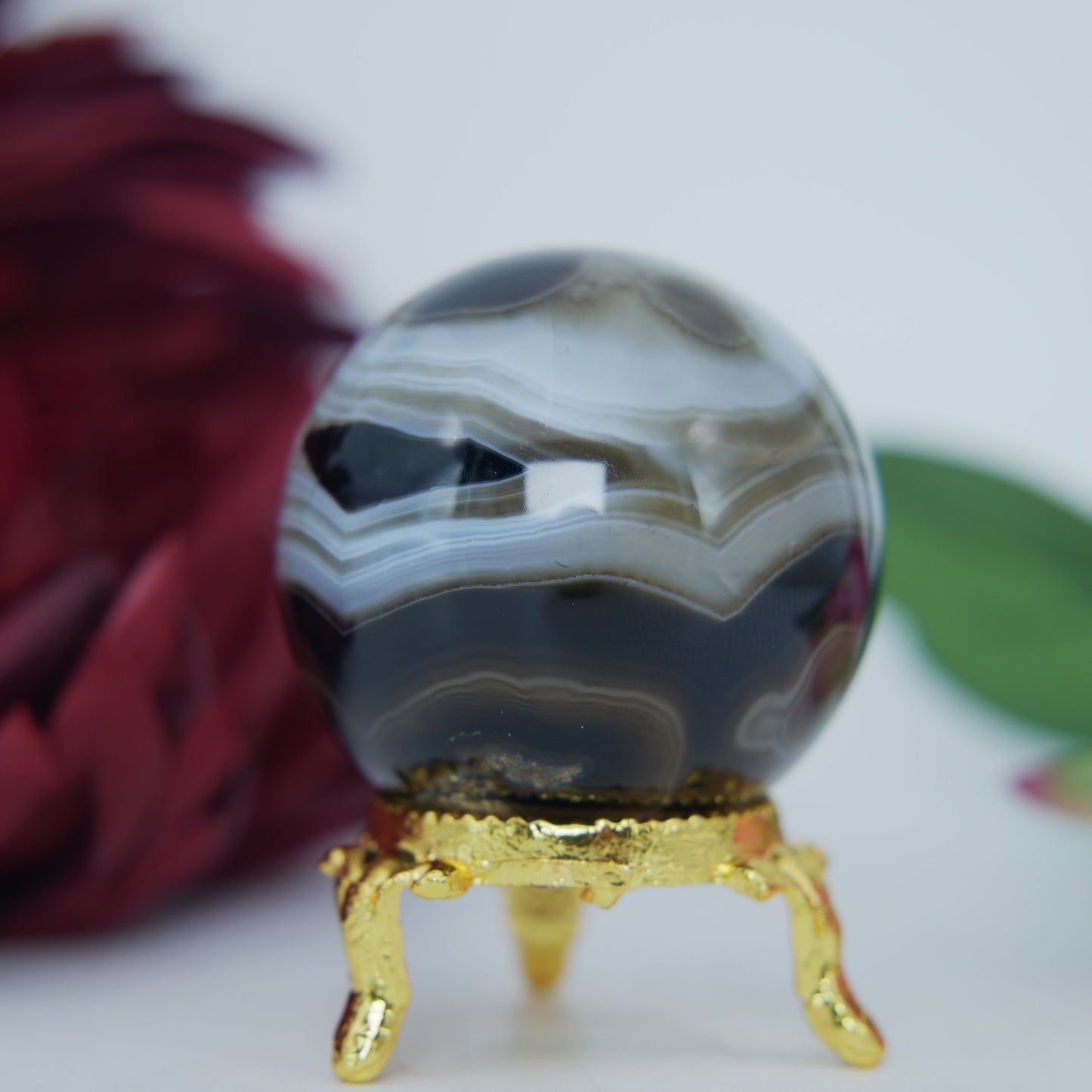Polished Black and White Agate Sulemani Sphere 130g featuring banded patterns and glossy finish - Luna Panther