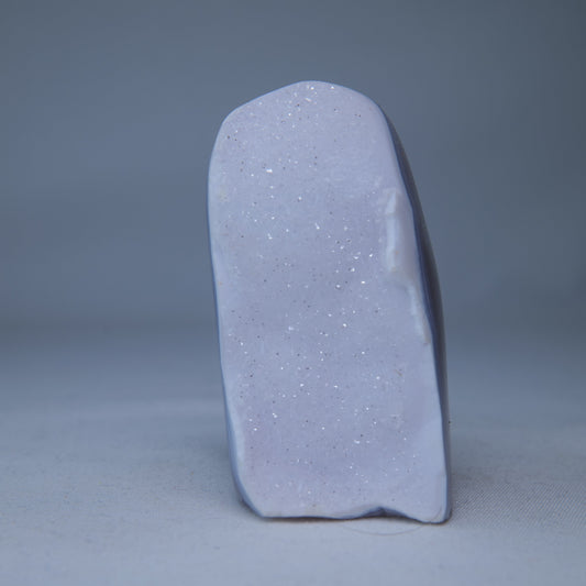 Upright pale blue-lavender Blue Lace Agate druzy freeform with a sparkling face and dark banded edge