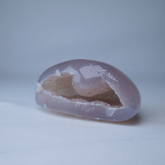 Druzy Geode 106g — A natural pale pink Druzy Geode with a polished outer surface and sparkling crystal-lined cavity. Product image 2 of 7. alternate view