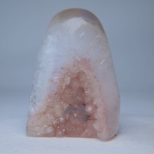 Front view of rose-pink druzy crystals in the pale rounded face of the 181g geode.