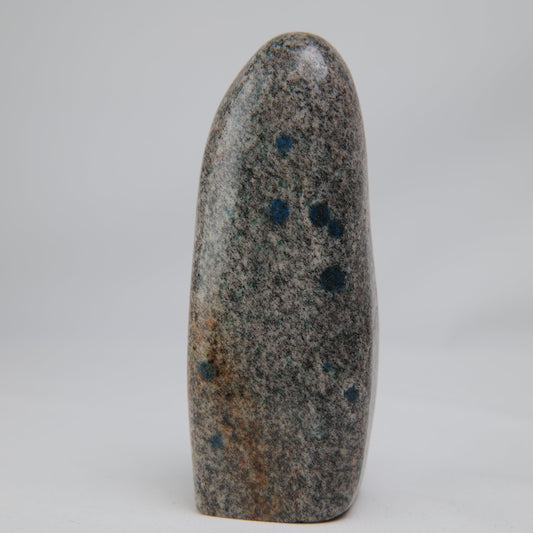 K2 Jasper freeform with a pale, finely speckled face and scattered deep-blue spots.