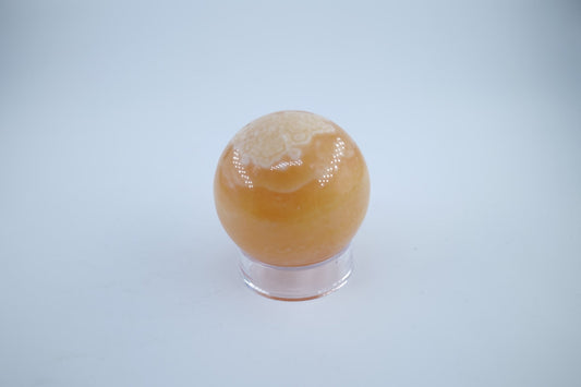 Polished Orange Calcite Sphere 289 grams featuring vivid orange tone and glassy sheen - Luna Panther