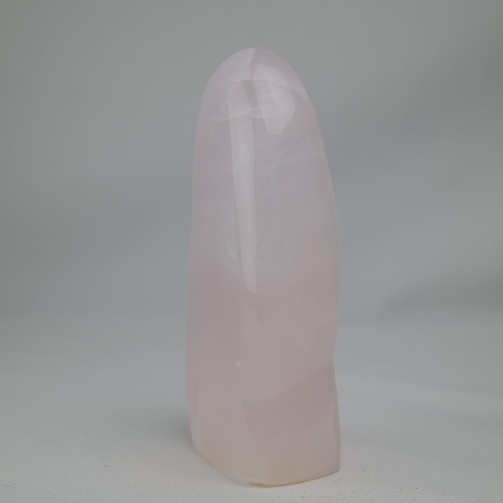 Pink Mangano Calcite freeform 313g polished side view