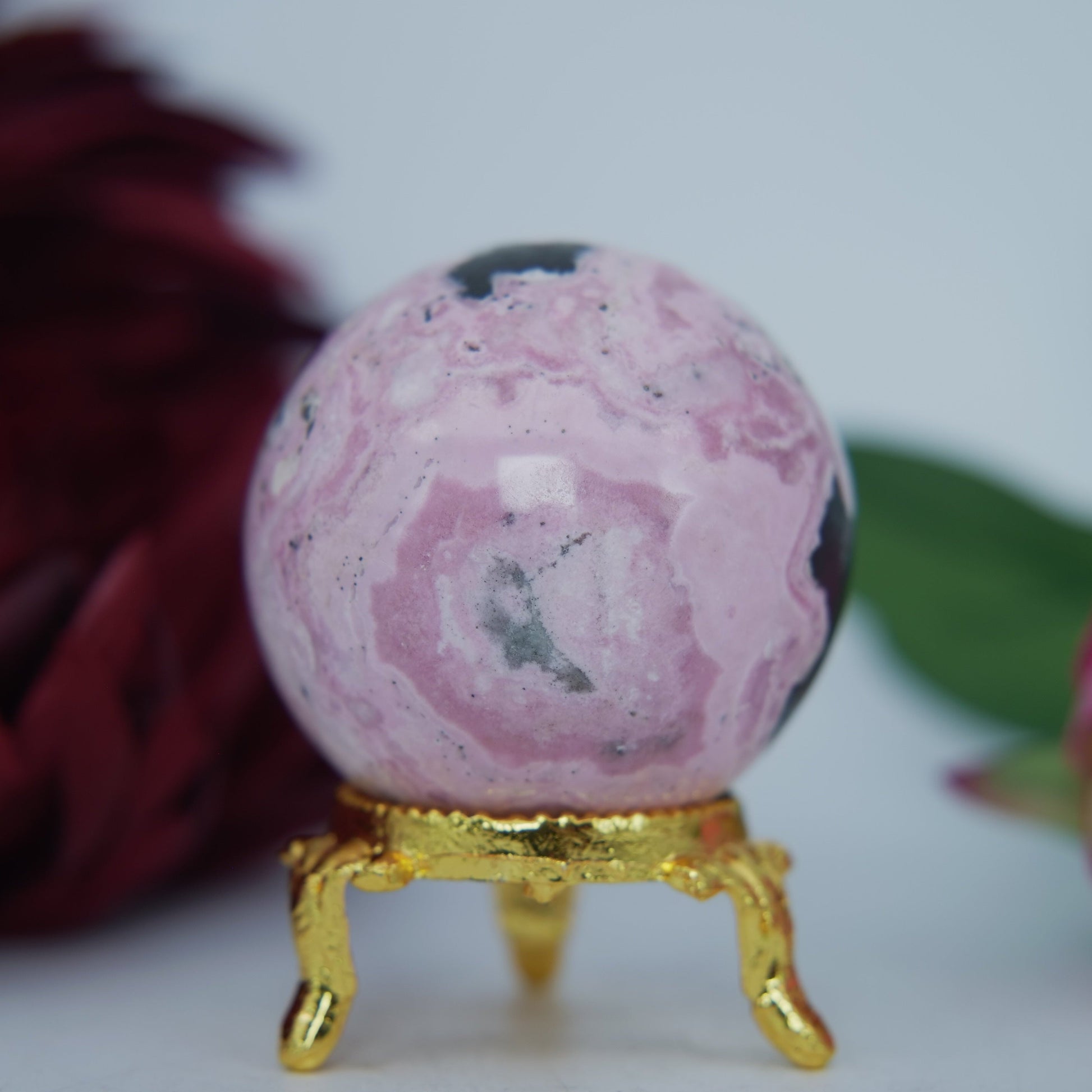 Polished Rhodochrosite Sphere 190g featuring pink bands and glassy finish - Luna Panther