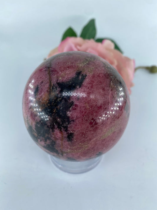 Polished Rhodonite Sphere 650 grams featuring pink tone with black veining - Luna Panther
