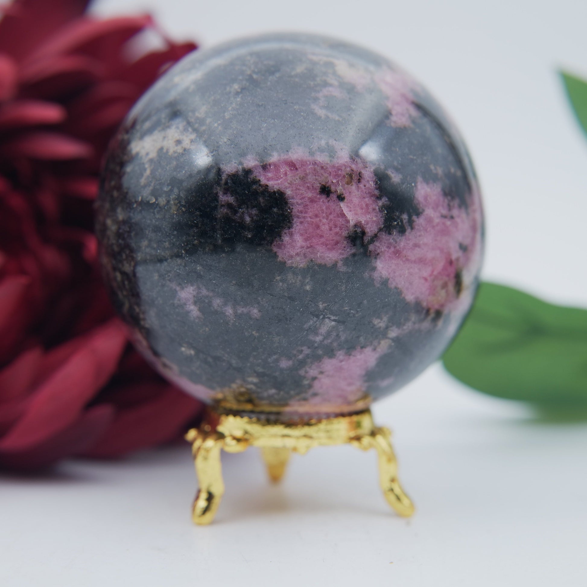 Polished Rhodonite Sphere Madagascar 693g featuring pink tone with black veining - Luna Panther