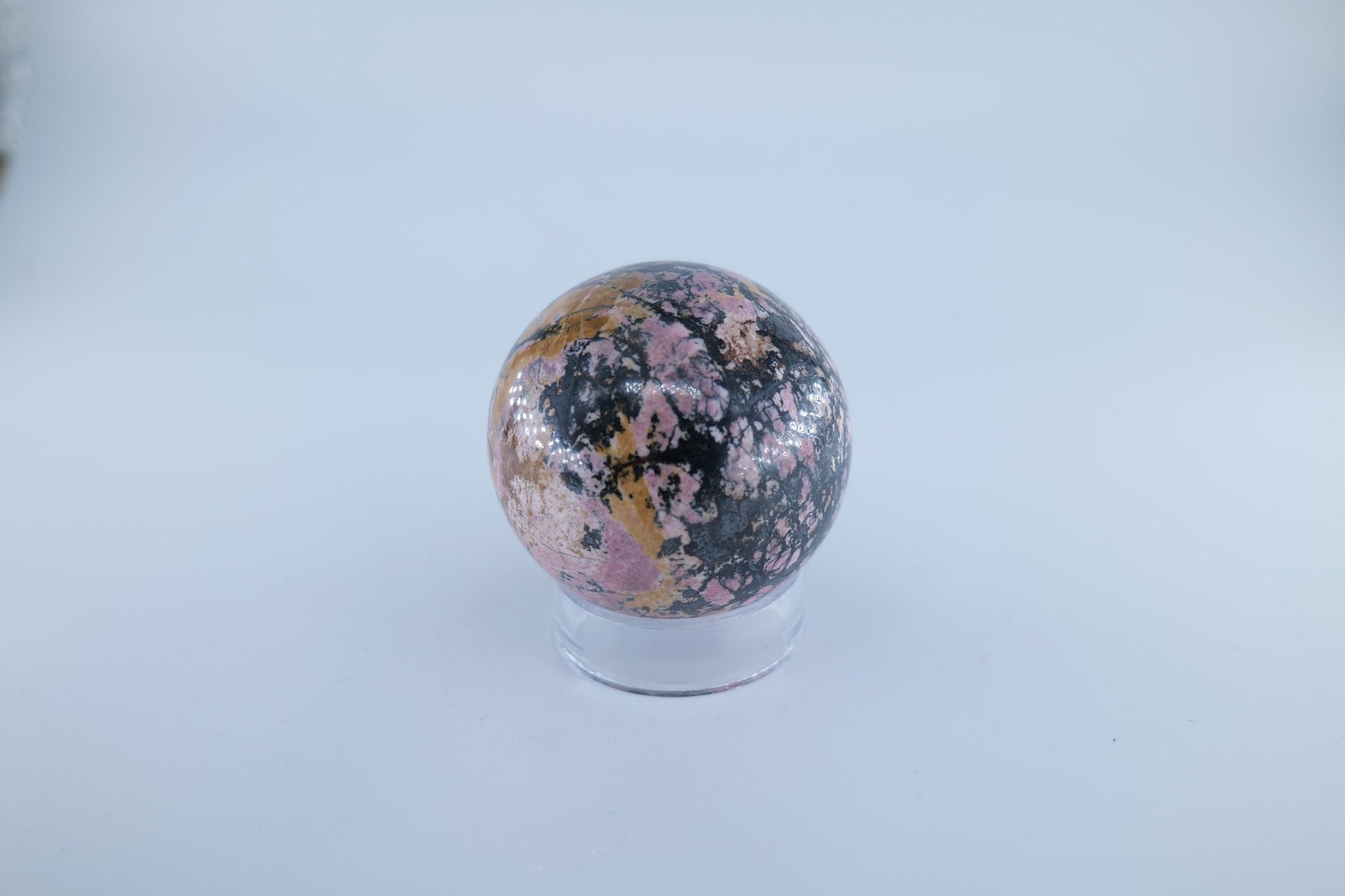 Polished Rhodonite Sphere Pakistan 440 grams featuring pink tone with black veining - Luna Panther