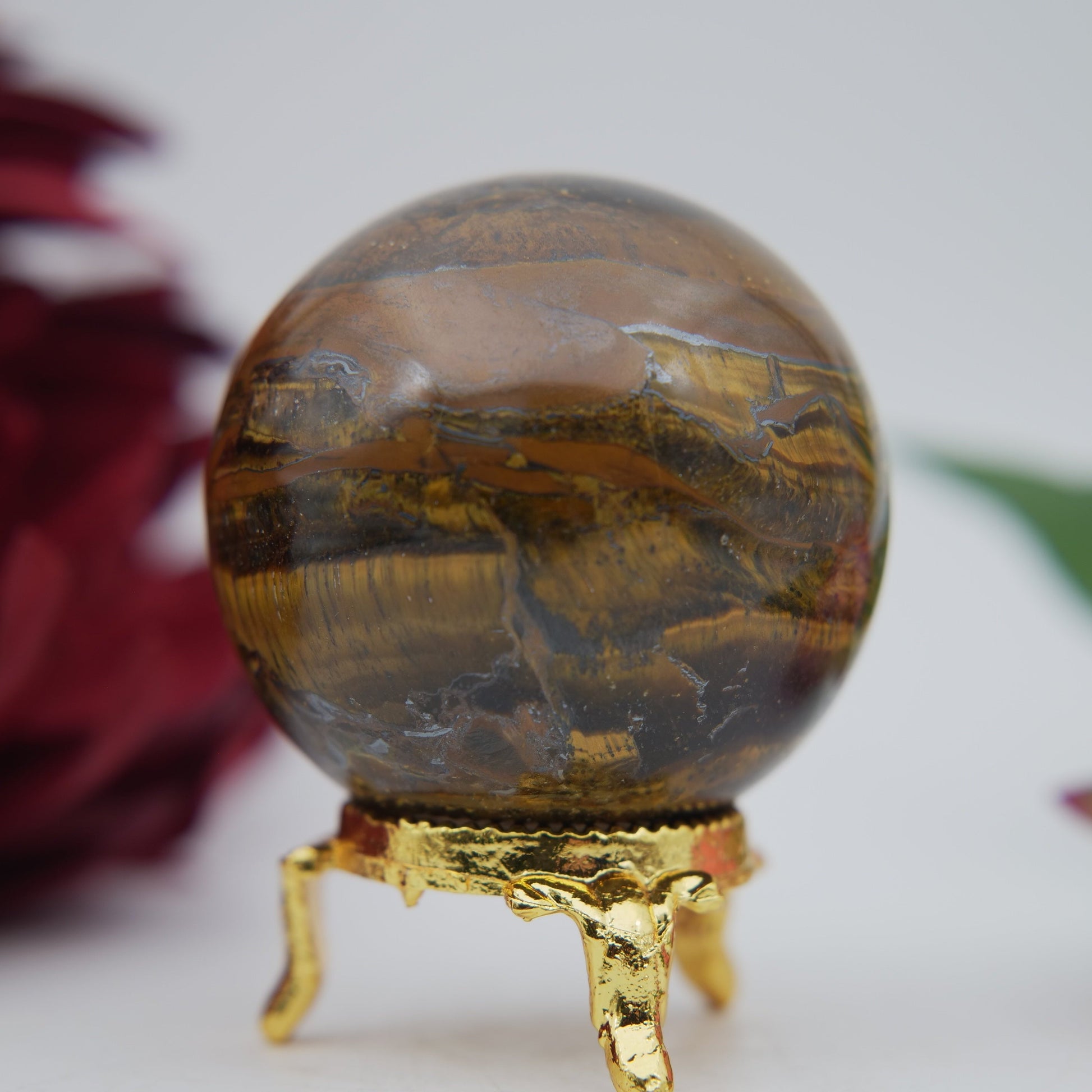 Polished Tigers Eye Sphere 210g 55mm featuring chatoyant golden-brown bands - Luna Panther